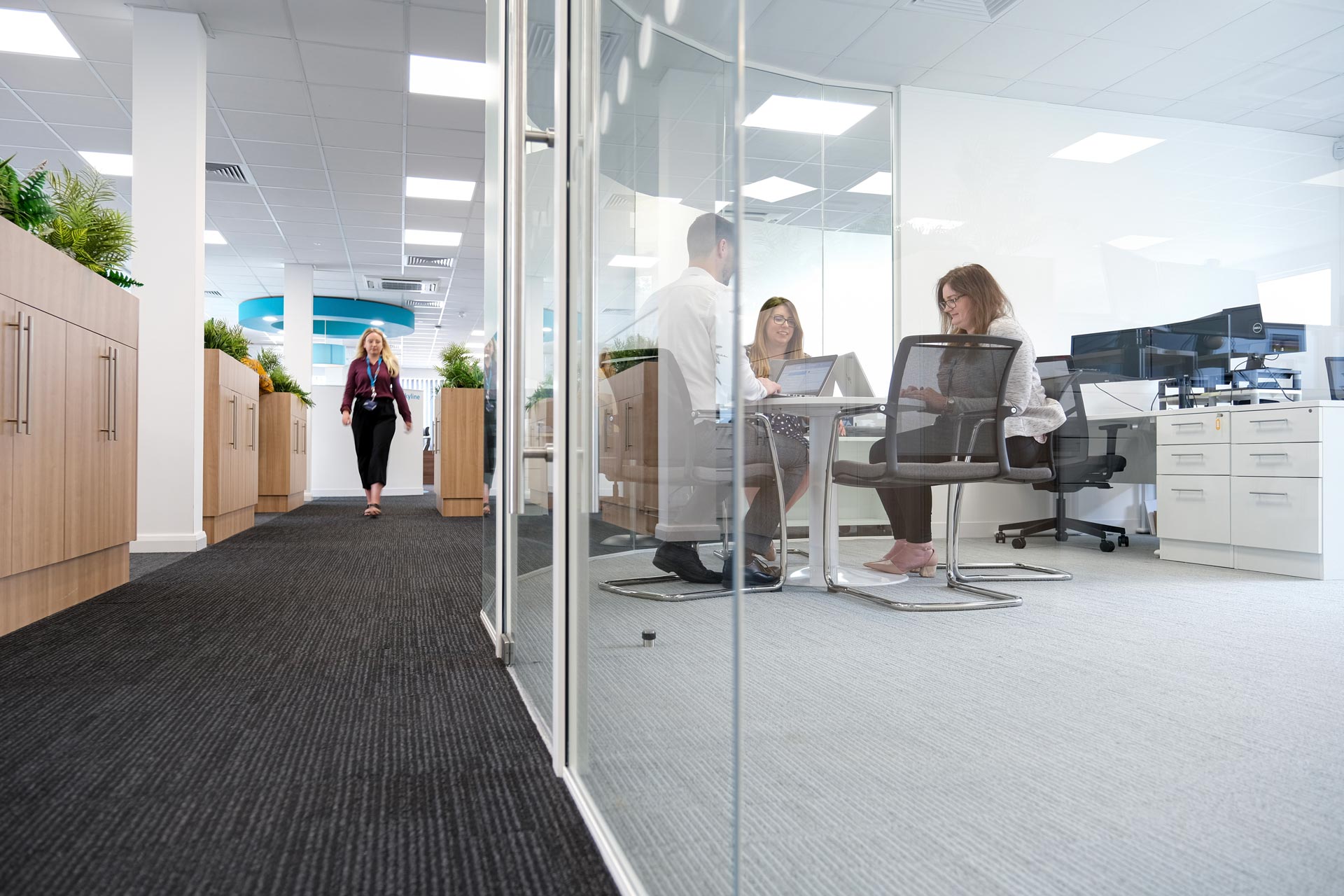 corridor and meeting room behind glass wall