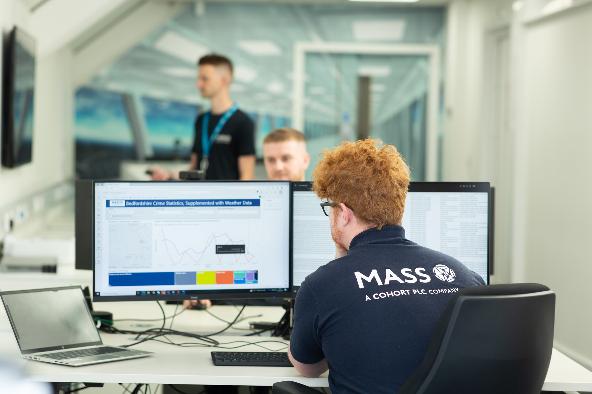 MASS employee looking at computer screens working on a public sector project