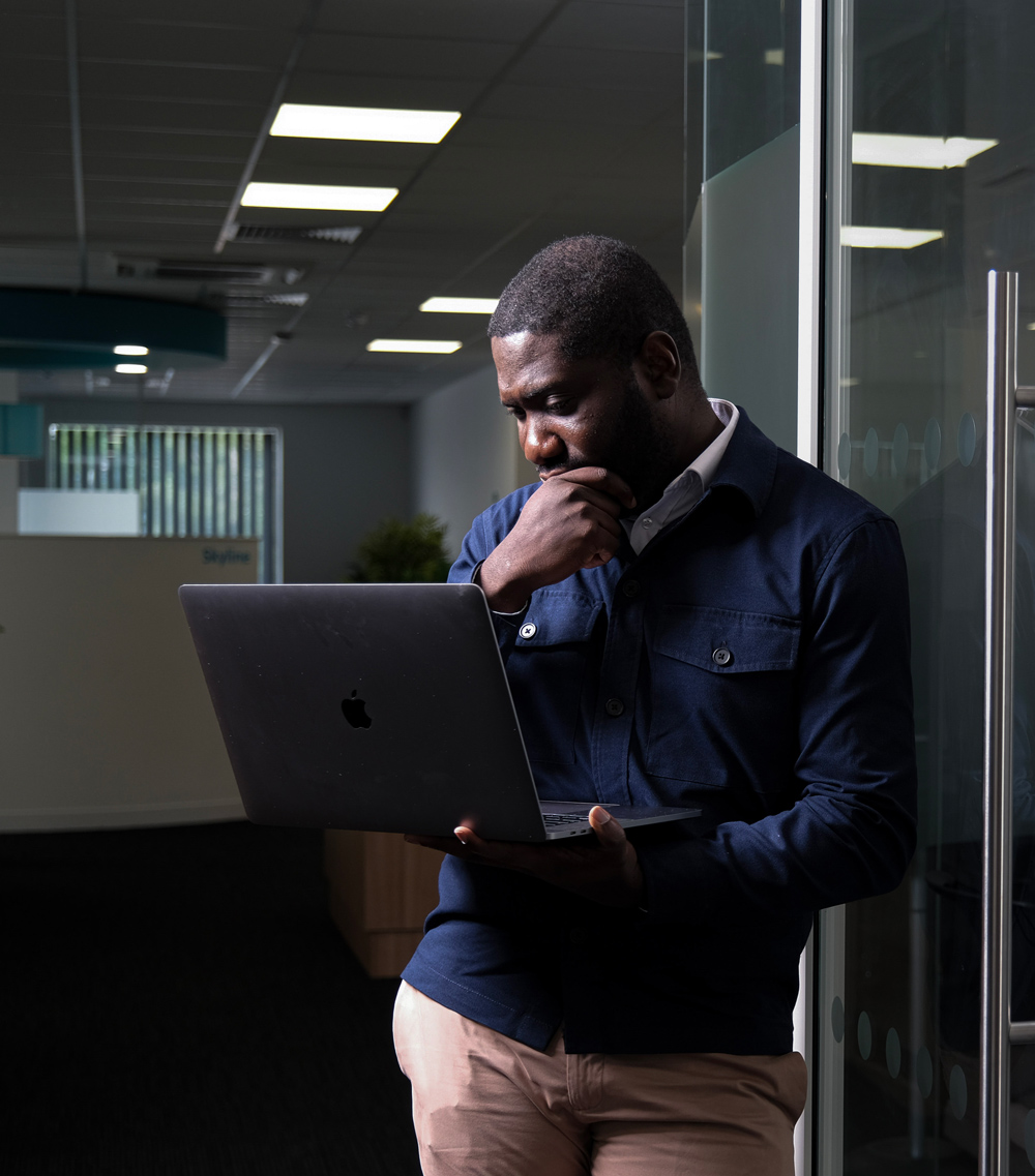 MASS employee holding laptop